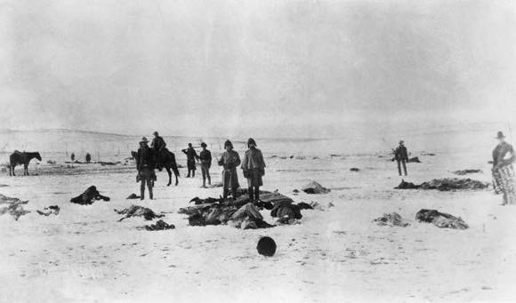Wounded Knee Massacre with dead individuals and others viewing them